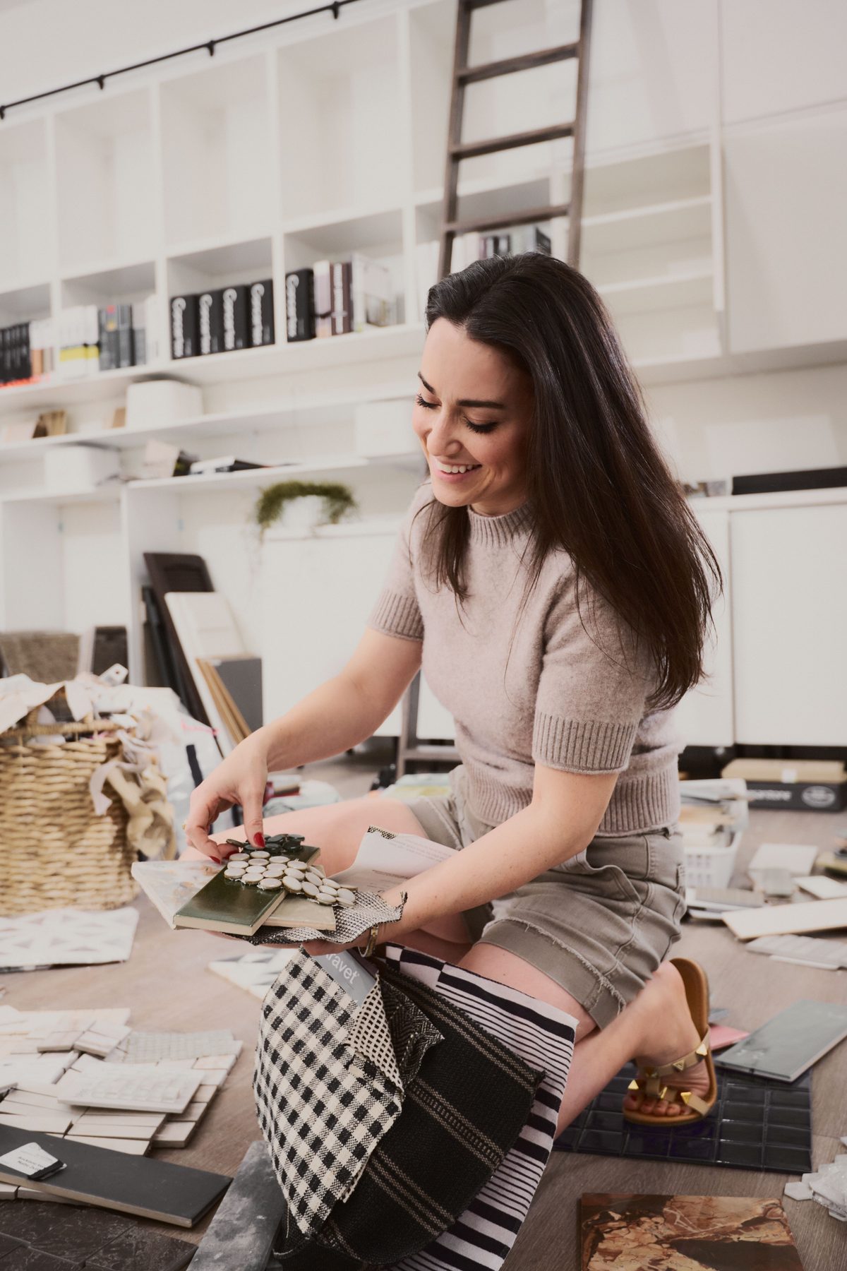 Shira Charles reviewing material samples in her design studio
